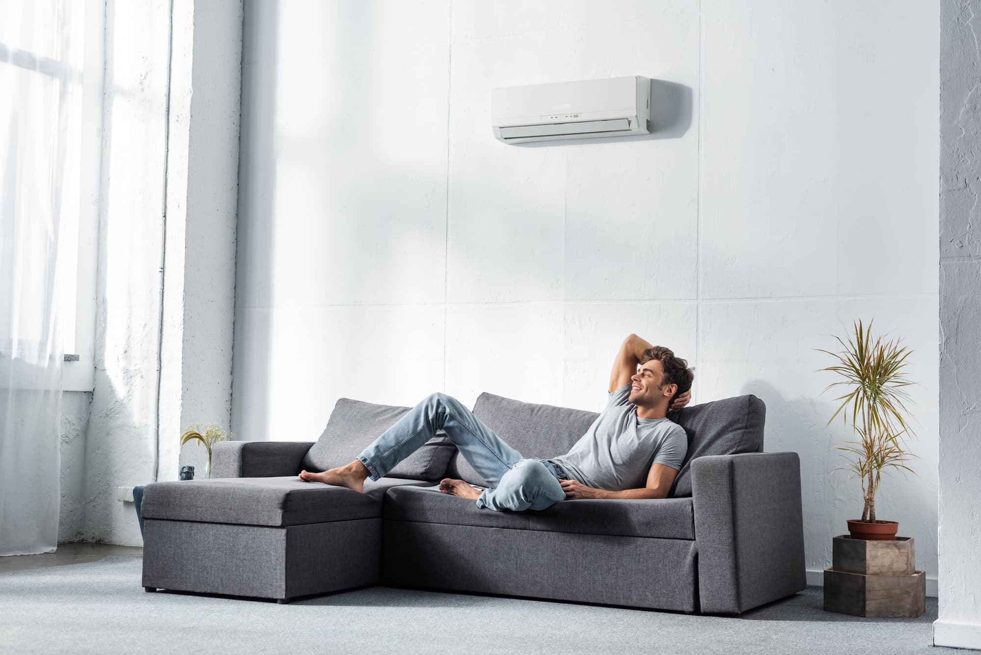 handsome-and-smiling-man-in-jeans-and-t-shirt-lying-on-sofa.jpg